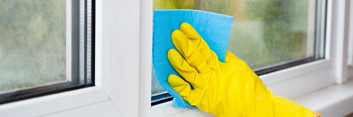Exterior window with visible water deposits during cleaning
